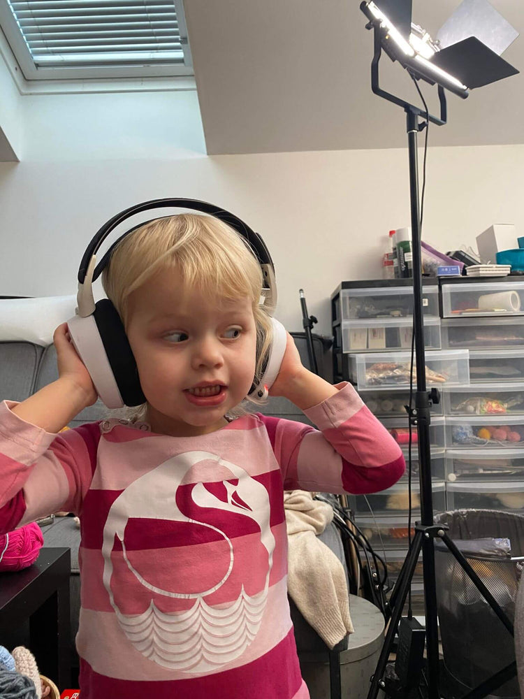 cute little girl trying on moms headphones