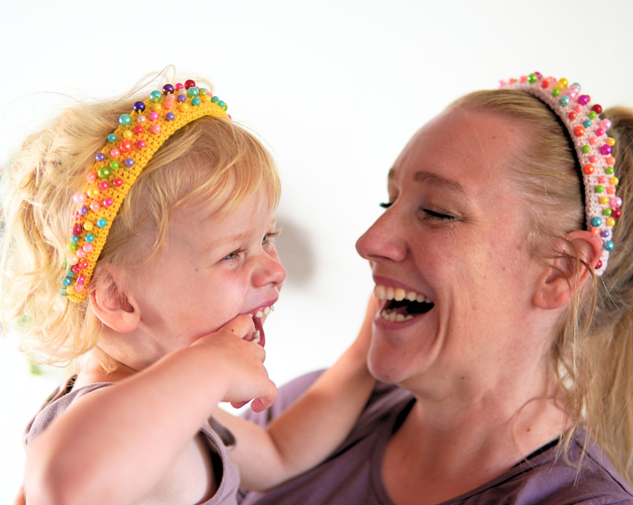 Girl and her mom wearing homemade crocheted headbands with beads
