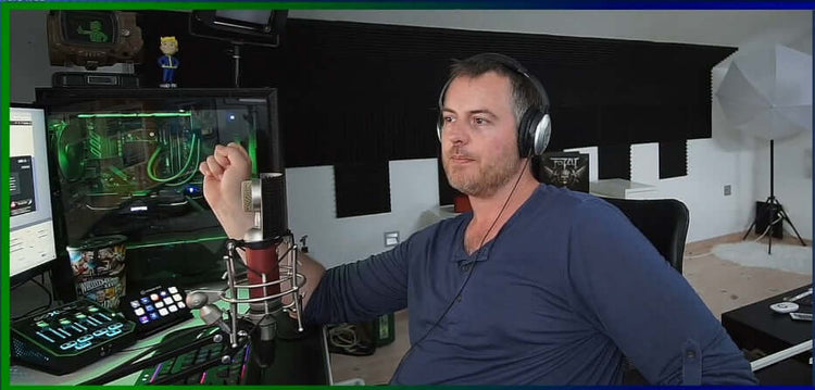 A man sitting in front of a computer and editing videos