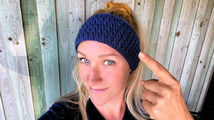 Girl pointing at her blue crocheted headband