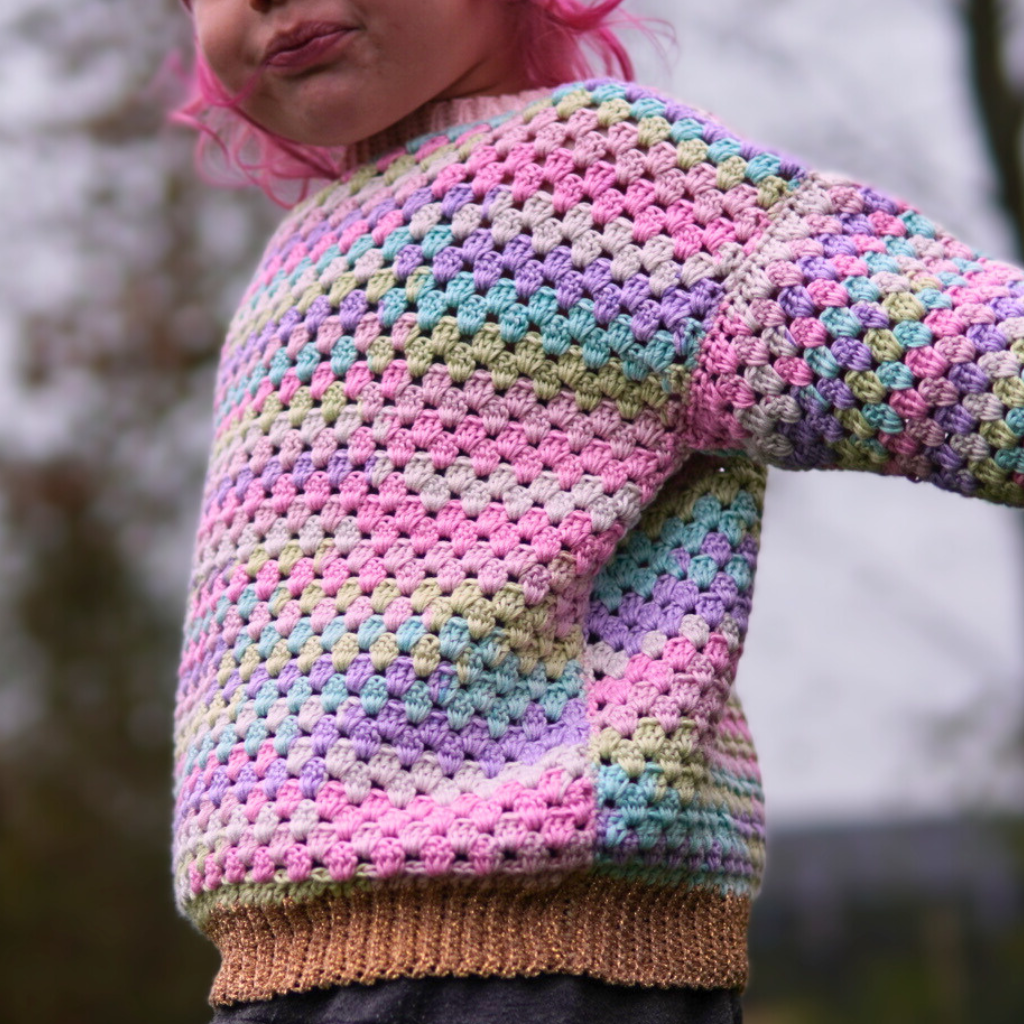 Granny stitch sweater crocheted in multicolored Acacia Yarn from Hobbii on a little girl