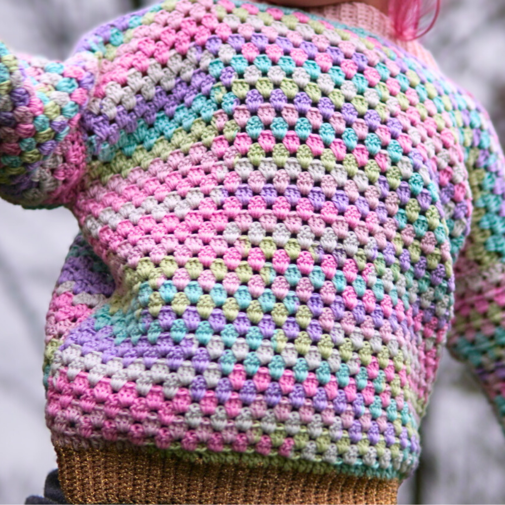 Granny stitch sweater crocheted in multicolored Acacia Yarn from Hobbii on a little girl