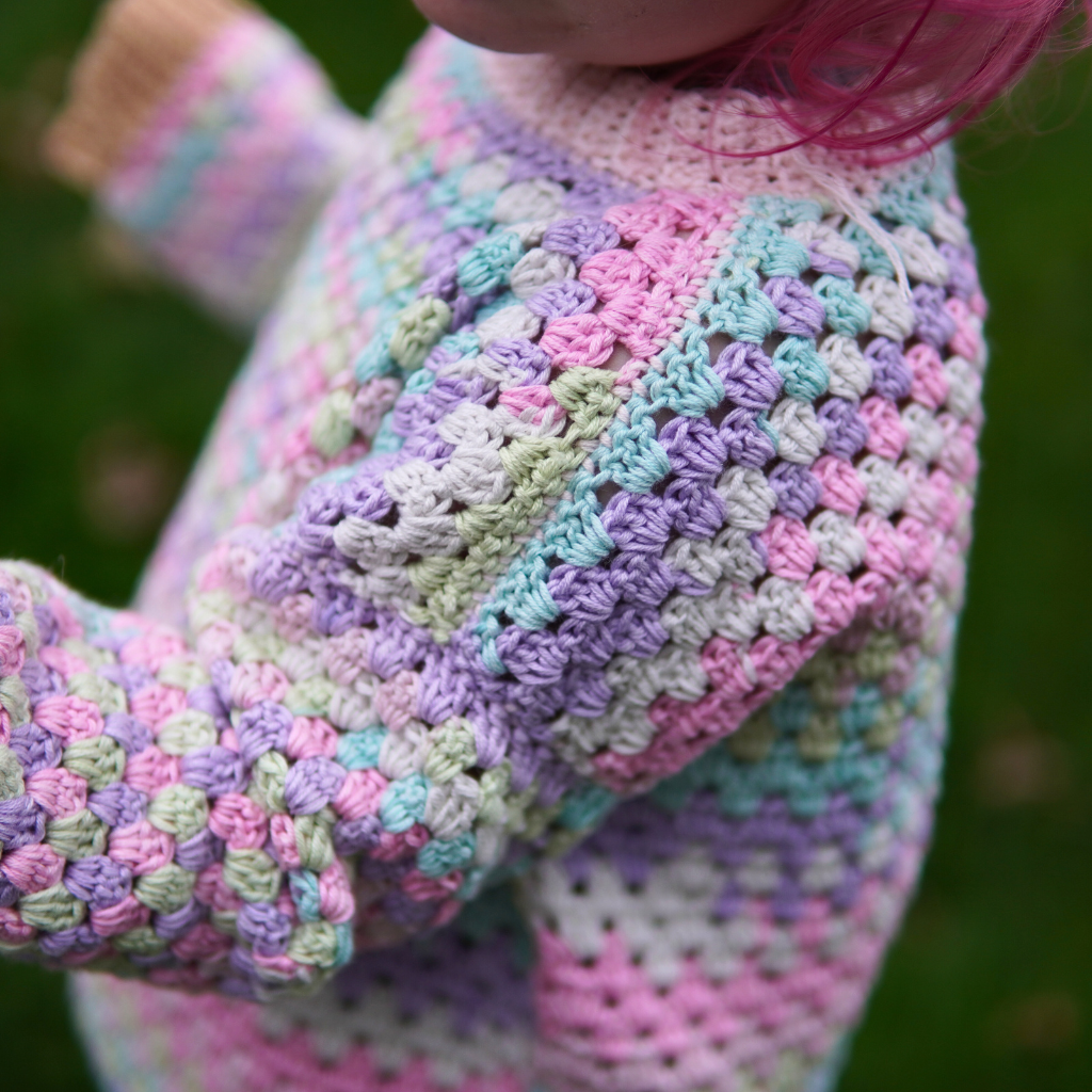 Granny stitch sweater crocheted in multicolored Acacia Yarn from Hobbii on a little girl