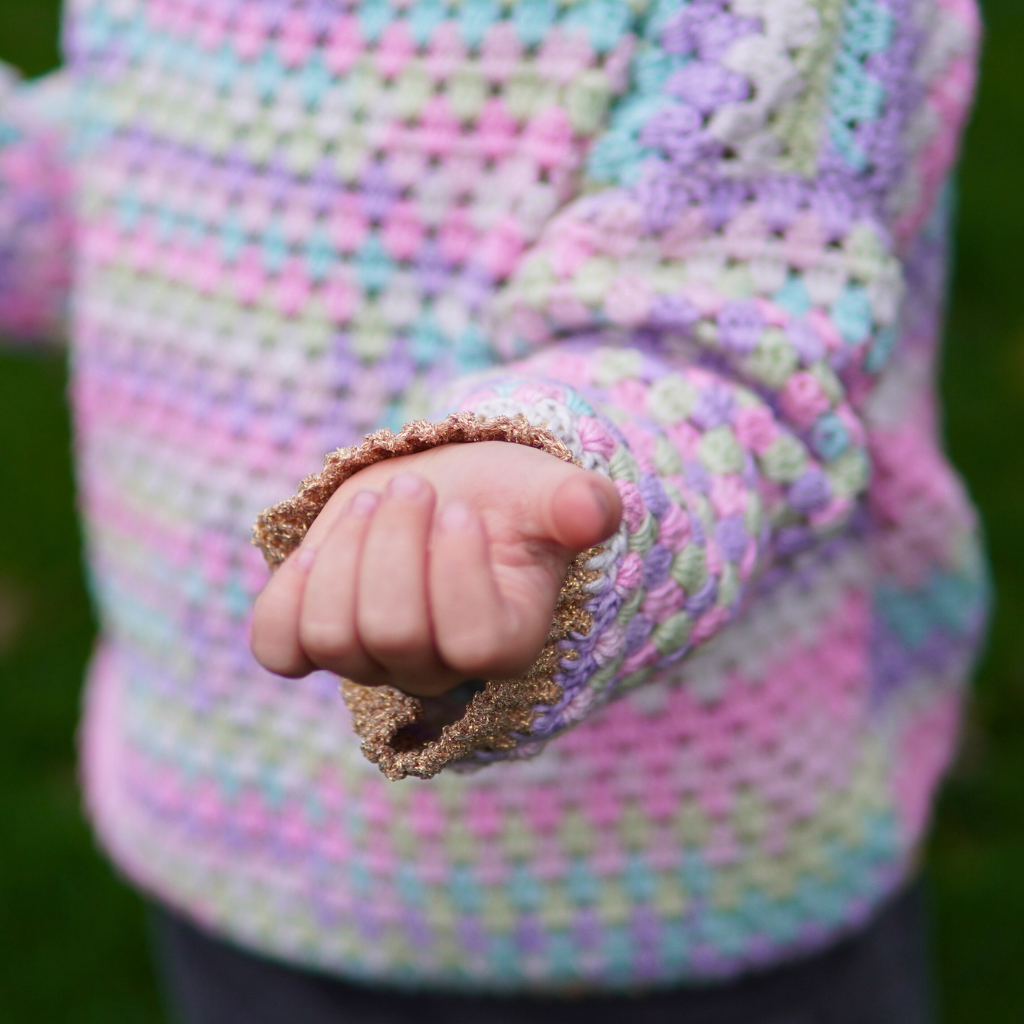 Granny stitch sweater crocheted in multicolored Acacia Yarn from Hobbii on a little girl