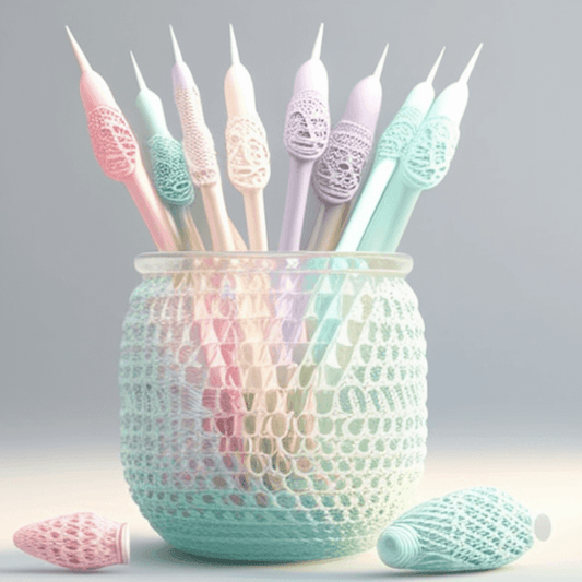 Crochet hooks in different sizes and colors, arranged in a cup on a table