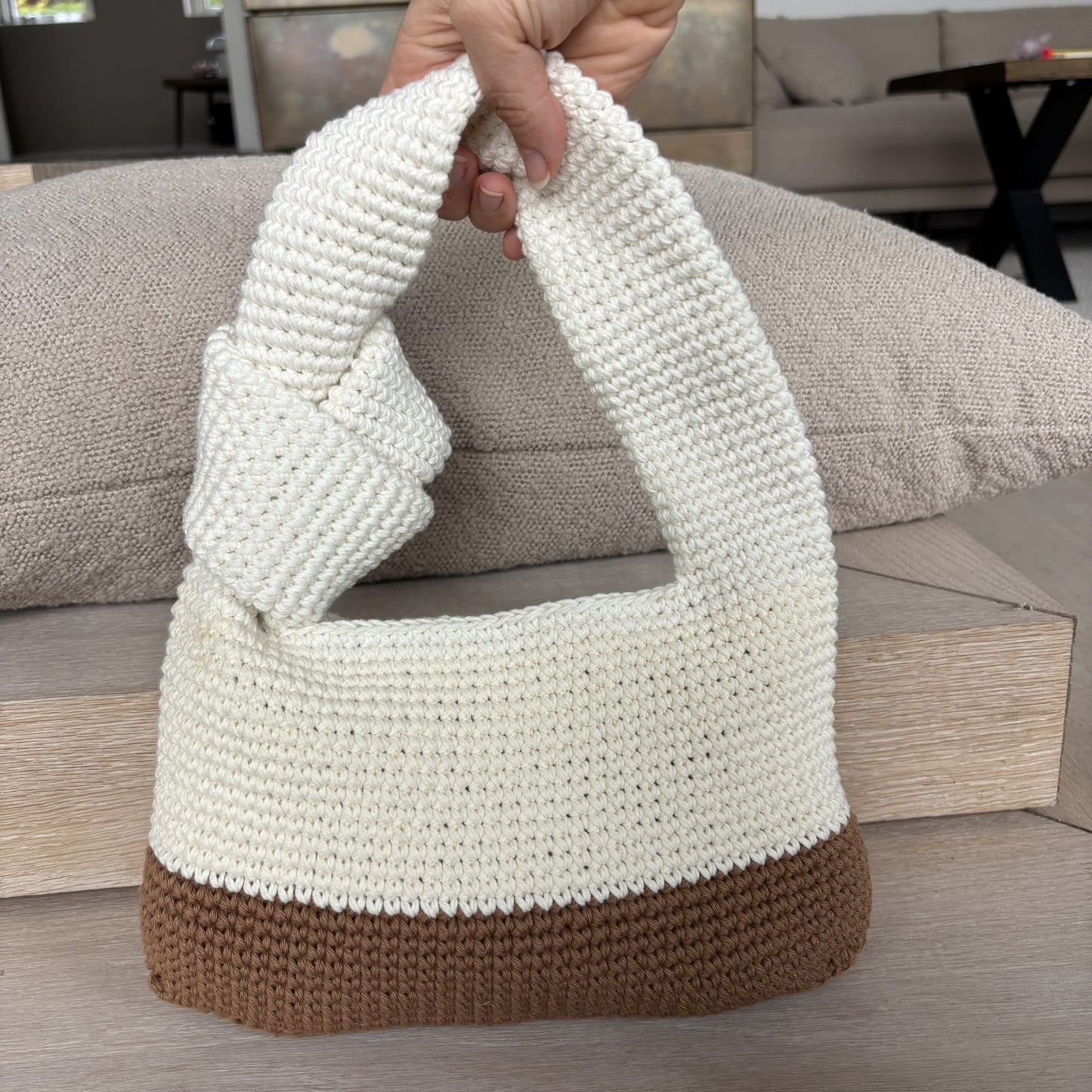 Digital PDF crochet pattern for a modern knotted handbag. Make a stylish crochet bag with a two-tone body, sturdy handle and knot detail. US terms.