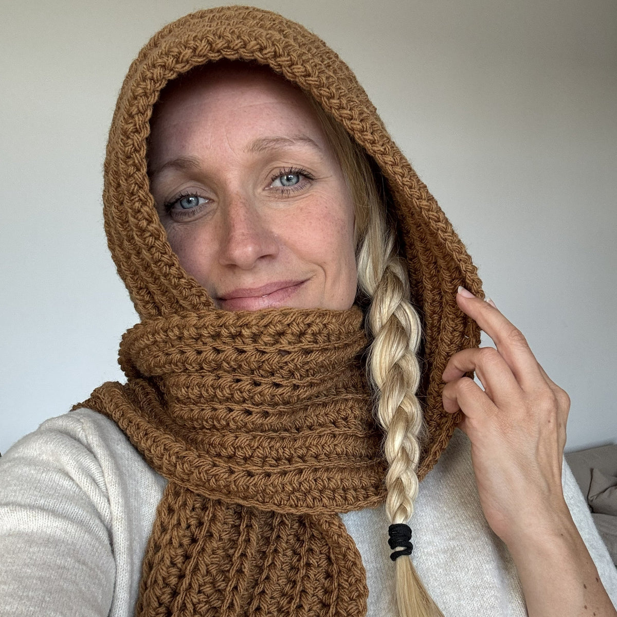 Woman wearing a brown chunky crochet hooded scarf made from bulky yarn