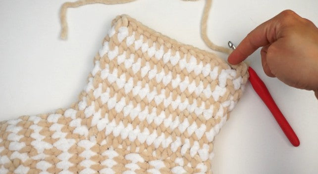 Crochet bootie slipper construction showing the heel and tall ankle section