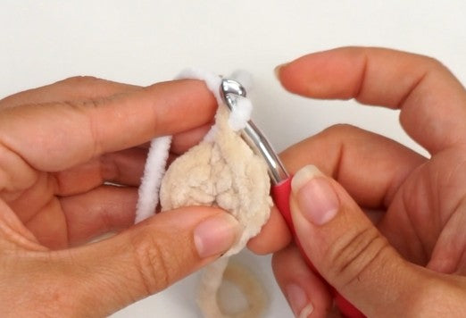 Crochet bootie slipper construction showing the start with a magic ring