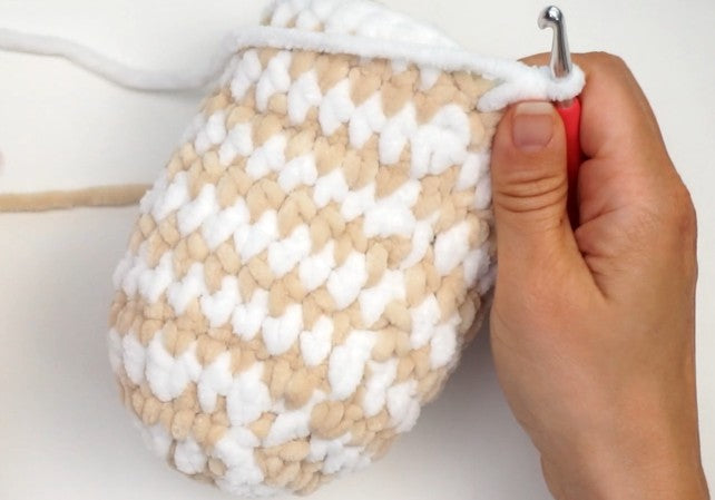 Close-up of chunky crochet slipper toe worked in beige and white super bulky yarn