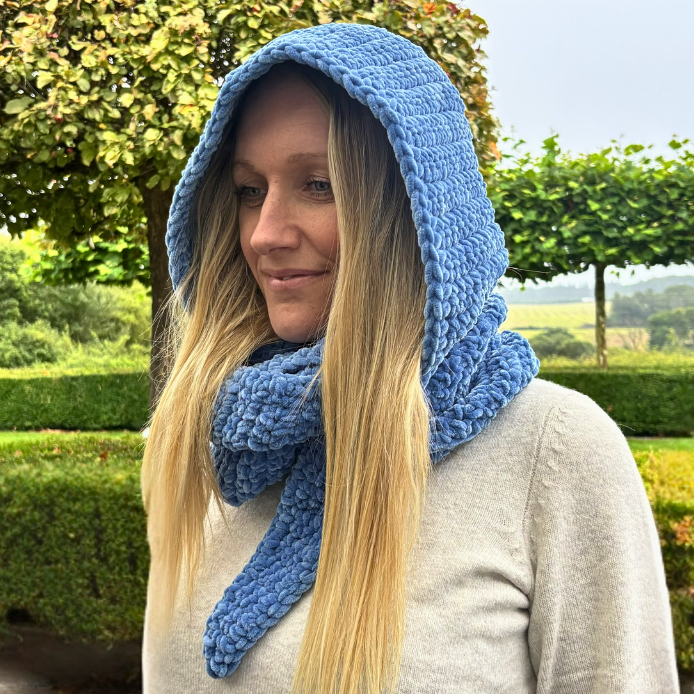 Woman wearing a blue bulky crochet hooded scarf Sophie Hood Inspired