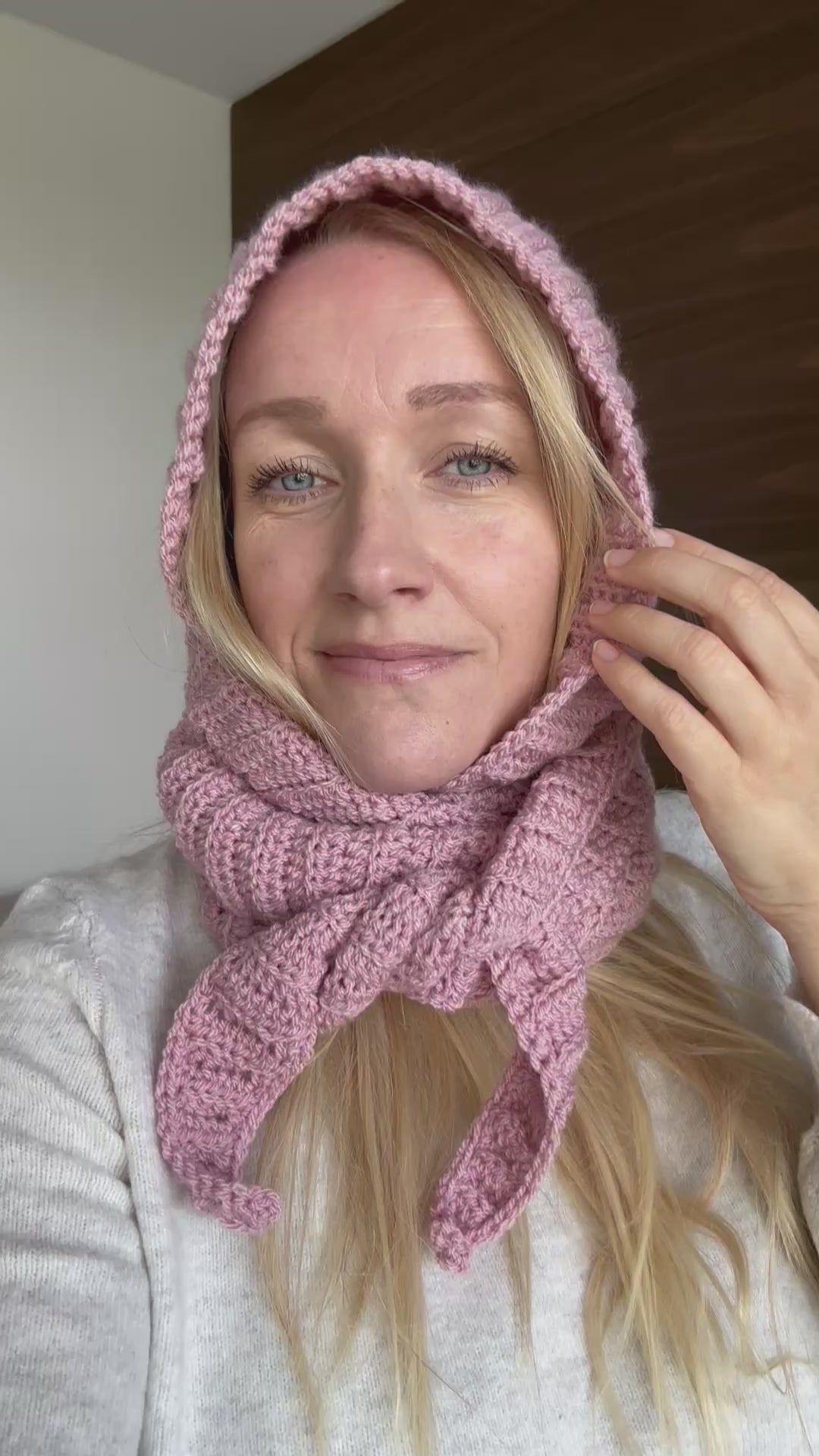 Pink ribbed crochet Sophie Hood worn with the scarf wrapped around the neck