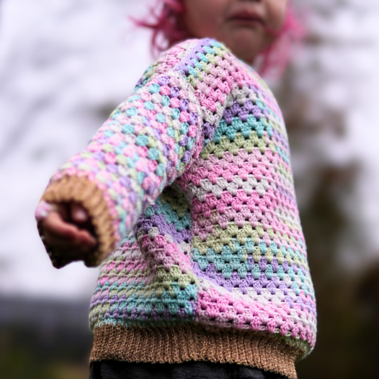 Granny stitch sweater crocheted in multicolored Acacia Yarn from Hobbii on a little girl