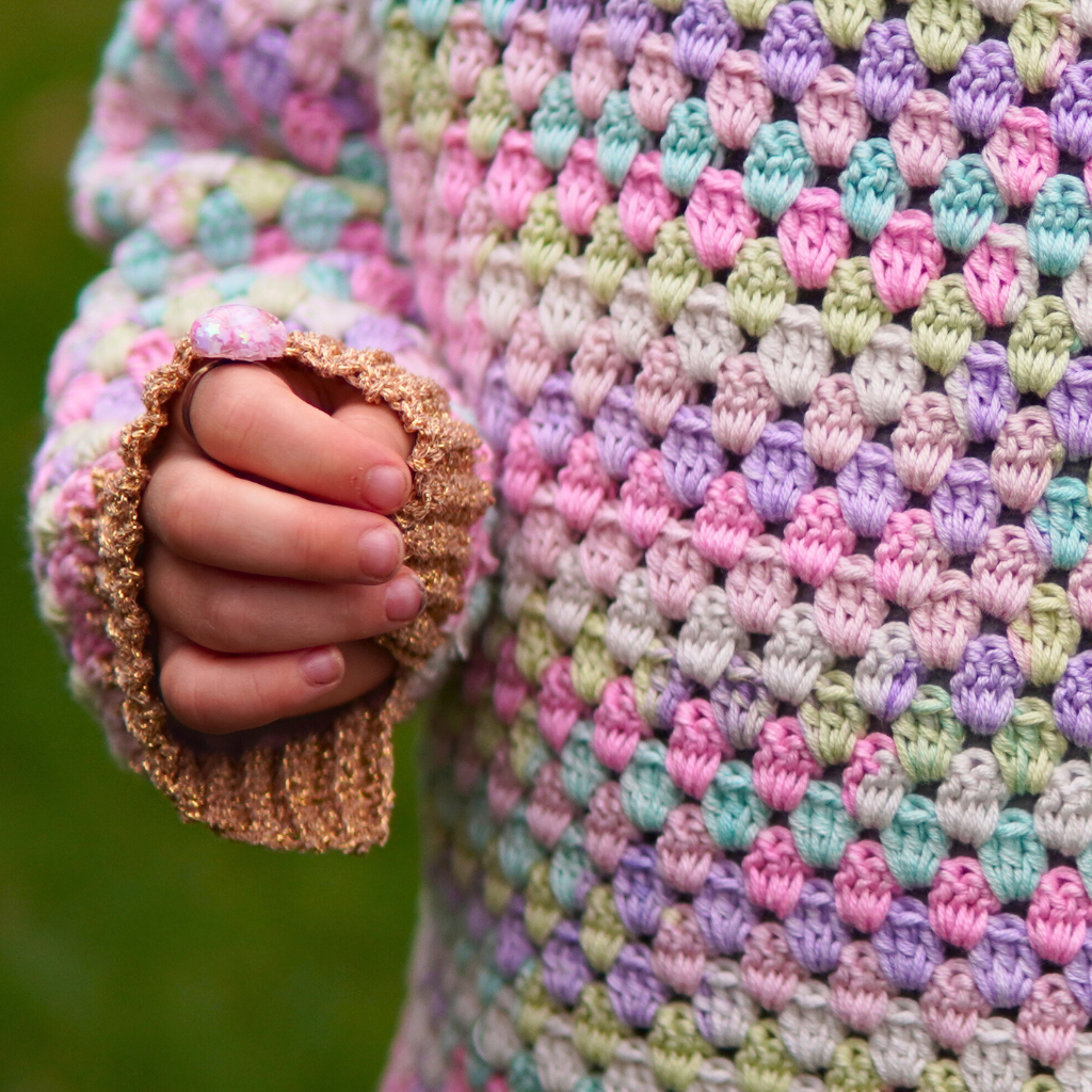 Granny stitch sweater crocheted in multicolored Acacia Yarn from Hobbii on a little girl
