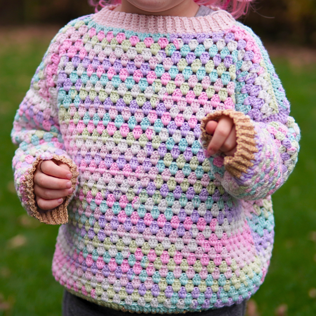 Granny stitch sweater crocheted in multicolored Acacia Yarn from Hobbii on a little girl